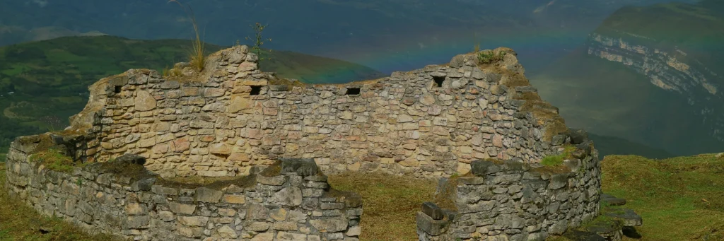 Serene sunset over a calm lake with a wooden dock in Chachapoyas, Peru, Kaymara Luxury Travel.