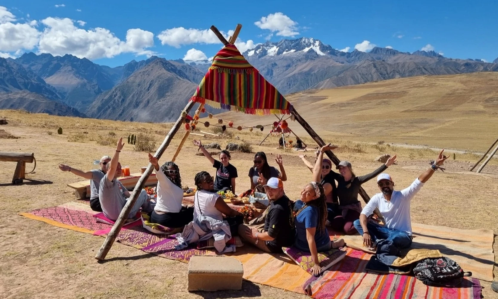 Vibrant landscape of lush green fields and snow-capped mountains in Maras, Cusco, Peru, Kaymara Luxury Travel.